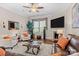 Cozy living room with plush seating, fireplace, ceiling fan, and large screen television at 21812 Chapel Way # 20, Cornelius, NC 28031