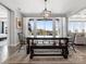 Charming dining room featuring a farmhouse table, bench seating, and large windows offering natural light and views of the outdoors at 2253 Prairie Rd, Concord, NC 28027