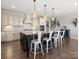 Spacious kitchen island with seating offers a gathering spot in a modern design with stainless steel appliances and stylish pendant lighting at 2253 Prairie Rd, Concord, NC 28027