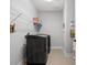 Well-lit laundry room featuring modern washer and dryer, wire shelving, and tile flooring at 2253 Prairie Rd, Concord, NC 28027