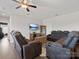 Cozy living room with hardwood floors, ceiling fan, and a leather sofa set at 2253 Prairie Rd, Concord, NC 28027