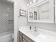 Stylish bathroom with subway tile, vanity with modern fixtures, and plenty of natural light at 2310 Roswell Ave # H, Charlotte, NC 28207