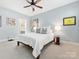 Cozy bedroom with plush carpet, ceiling fan, natural light and a neutral color palette at 2310 Roswell Ave # H, Charlotte, NC 28207