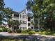 Attractive multi-story condo with multiple balconies and well-maintained landscaping and yard at 2310 Roswell Ave # H, Charlotte, NC 28207