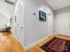 Hallway with hardwood floors and neutral gray walls, offering a glimpse into the rest of the home at 2310 Roswell Ave # H, Charlotte, NC 28207