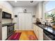 Well-lit kitchen with modern appliances, granite countertops, and hardwood flooring for an updated look at 2310 Roswell Ave # H, Charlotte, NC 28207