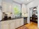 Bright kitchen featuring granite countertops, stainless steel dishwasher, and hardwood flooring at 2310 Roswell Ave # H, Charlotte, NC 28207