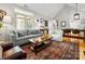 Spacious living room with a vaulted ceiling, hardwood floors, and an open layout to the dining area at 2310 Roswell Ave # H, Charlotte, NC 28207