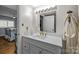 Bathroom showcasing a vanity with white countertop and ample lighting at 2503 Roswell Ave # 208, Charlotte, NC 28209