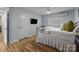Bedroom offers wood floors, natural light, and a flat-screen television at 2503 Roswell Ave # 208, Charlotte, NC 28209
