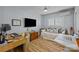 Bedroom featuring natural light, hardwood flooring, and a dedicated workspace at 2503 Roswell Ave # 208, Charlotte, NC 28209