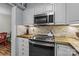 Well-equipped kitchen with stainless steel appliances and warm wooden countertops at 2503 Roswell Ave # 208, Charlotte, NC 28209