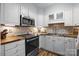 Charming kitchen featuring white cabinets, stainless steel appliances, and wooden countertops at 2503 Roswell Ave # 208, Charlotte, NC 28209