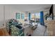 Bright living room features modern decor, stylish seating, and access to a spacious outdoor balcony at 2503 Roswell Ave # 208, Charlotte, NC 28209