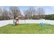 Spacious backyard with a playset, swing set and fire pit area with colorful Adirondack chairs at 2766 Sherrills Stream Dr, Sherrills Ford, NC 28673