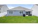 Well-manicured backyard showing the home's exterior, lush grass, and white picket fence at 2766 Sherrills Stream Dr, Sherrills Ford, NC 28673