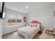 This colorful bedroom features a large window, wood-look floors, and fun decor at 2766 Sherrills Stream Dr, Sherrills Ford, NC 28673