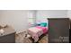 This bedroom has wood-look floors, a colorful bed, and a large window for natural light at 2766 Sherrills Stream Dr, Sherrills Ford, NC 28673