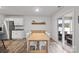 Bright dining area adjacent to the kitchen, featuring a wooden table, sliding glass doors to the outside, and stainless appliances at 2766 Sherrills Stream Dr, Sherrills Ford, NC 28673