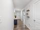 Bright and inviting hallway with hardwood flooring, and decorative shelving, adjacent to the front door at 2766 Sherrills Stream Dr, Sherrills Ford, NC 28673