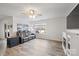 Bright living room boasts a ceiling fan, fireplace, wood-look flooring and sliding glass doors to the outdoor area at 2766 Sherrills Stream Dr, Sherrills Ford, NC 28673
