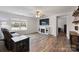 Cozy living room with hardwood floors, a fireplace, large windows, and a comfortable seating arrangement at 2766 Sherrills Stream Dr, Sherrills Ford, NC 28673