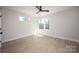 Bedroom featuring hardwood floors, natural light from the windows and a modern ceiling fan at 3020 Georgia Ave, Charlotte, NC 28205