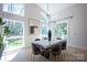 Contemporary dining area with large windows, modern light fixture, and seating for six at 3020 Georgia Ave, Charlotte, NC 28205
