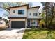 Contemporary two-story home featuring a modern design, gray garage door, and landscaped front yard at 3020 Georgia Ave, Charlotte, NC 28205