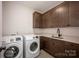 Laundry room featuring washer and dryer with counter and cabinet space at 3020 Georgia Ave, Charlotte, NC 28205