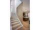 Staircase leading to modern kitchen with island and stainless steel appliances at 3020 Georgia Ave, Charlotte, NC 28205