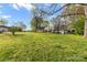 Expansive grassy backyard with mature trees, perfect for outdoor activities and enjoying nature at 310 N Central Ave, Landis, NC 28088