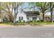 Charming white home with a covered porch and mature trees in a peaceful neighborhood at 310 N Central Ave, Landis, NC 28088