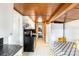 Galley kitchen featuring white cabinets, wooden ceiling, and all necessary appliances at 310 N Central Ave, Landis, NC 28088