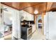 Functional kitchen with a view into the bedroom, white cabinets, and standard appliances at 310 N Central Ave, Landis, NC 28088