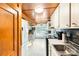 Traditional kitchen with white cabinets, wooden ceiling, and appliances for easy meal preparation at 310 N Central Ave, Landis, NC 28088