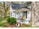 Inviting front porch with hanging flower baskets, a swing, and seating for relaxing outdoors at 310 N Central Ave, Landis, NC 28088