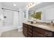 Well-lit bathroom featuring a double sink vanity with granite countertops, a bathtub/shower combo, and ample mirror space at 314 Contentment Dr # 192B, Locust, NC 28097