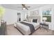 Comfortable bedroom with a well-appointed bed, soft lighting, and a view of the outdoors through bright windows at 314 Contentment Dr # 192B, Locust, NC 28097