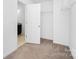 A spare closet area featuring neutral carpet and a wire rack for optimal storage at 314 Contentment Dr # 192B, Locust, NC 28097
