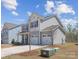 Charming two-story home featuring a two-car garage and beautifully landscaped front yard, with light-grey siding at 314 Contentment Dr # 192B, Locust, NC 28097