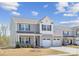 Charming two-story home featuring a two-car garage and beautifully landscaped front yard, with light-grey siding at 314 Contentment Dr # 192B, Locust, NC 28097