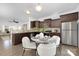 Stylish eat-in kitchen featuring stainless steel appliances, dark wood cabinets, granite countertops, and modern lighting at 314 Contentment Dr # 192B, Locust, NC 28097