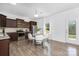 Bright kitchen with stainless steel appliances, dark wood cabinets, and a charming dining area with a round table at 314 Contentment Dr # 192B, Locust, NC 28097