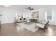 Bright, open-concept living room with hardwood floors, stylish furnishings, and plenty of natural light at 314 Contentment Dr # 192B, Locust, NC 28097