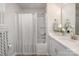 Bright bathroom featuring a shower-tub combo, white cabinets, a light countertop, and wood-look flooring at 344 F Lincoln St, Concord, NC 28025