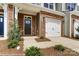 Welcoming front exterior featuring a brick facade, attached garage, and manicured landscaping at 4217 Black Ct # 194, Harrisburg, NC 28075