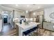Modern kitchen featuring an island with seating, stainless steel appliances, and bright lighting at 4217 Black Ct # 194, Harrisburg, NC 28075
