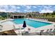 Community pool with lounge chairs, umbrellas, and clubhouse at 4217 Black Ct # 194, Harrisburg, NC 28075