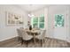 Bright dining area with modern chandelier and large window with backyard views at 4217 Whispering Oaks Dr, Charlotte, NC 28213